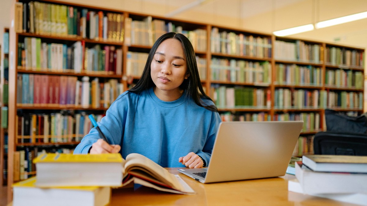 young-woman-writing-in-library.jpg